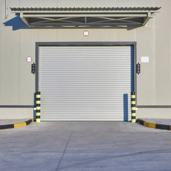 Shutter door or rolling door beige color, at new factory construction site and concrete floor